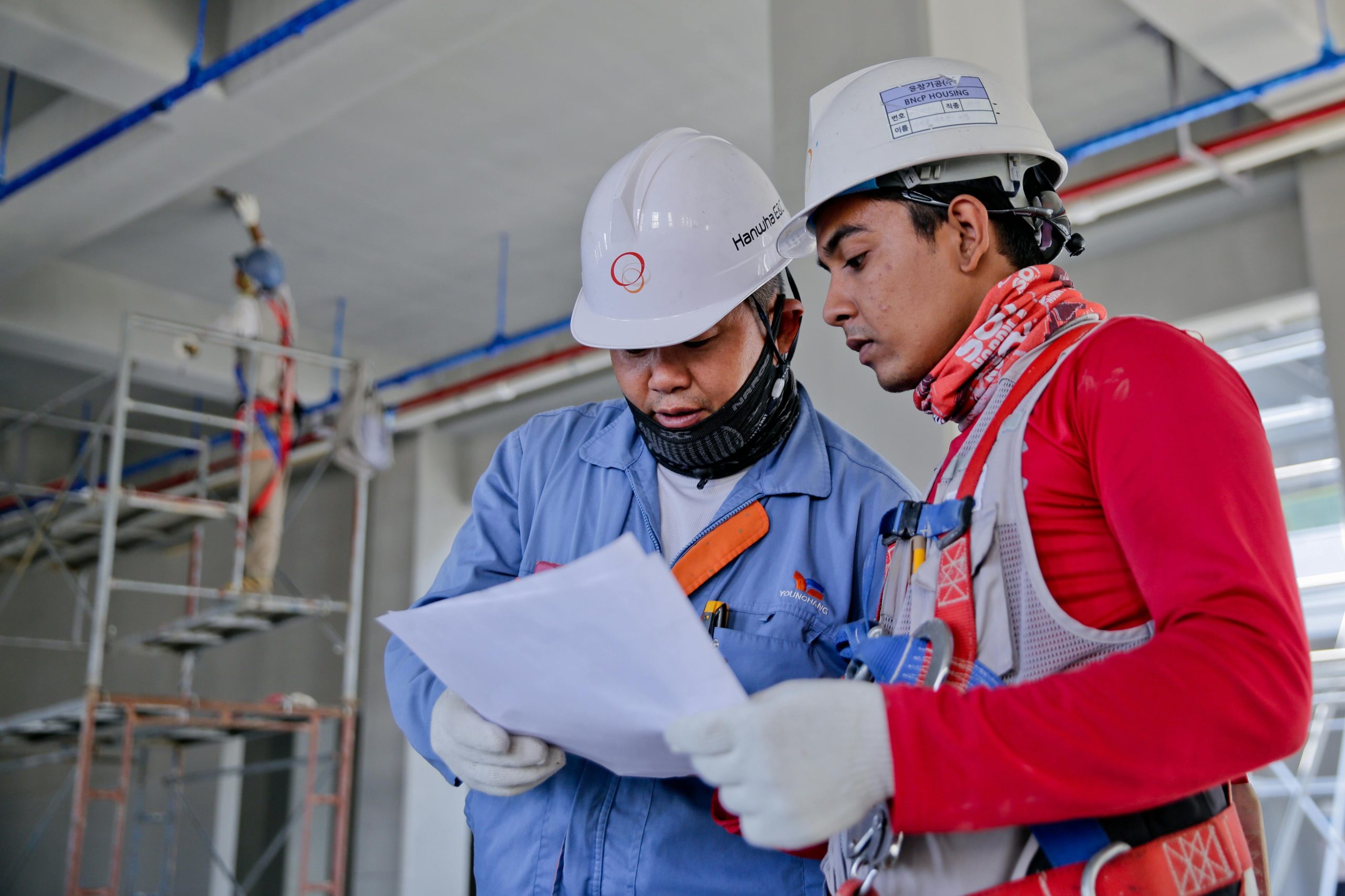 Workers wearing protective gear while performing asbestos abatement