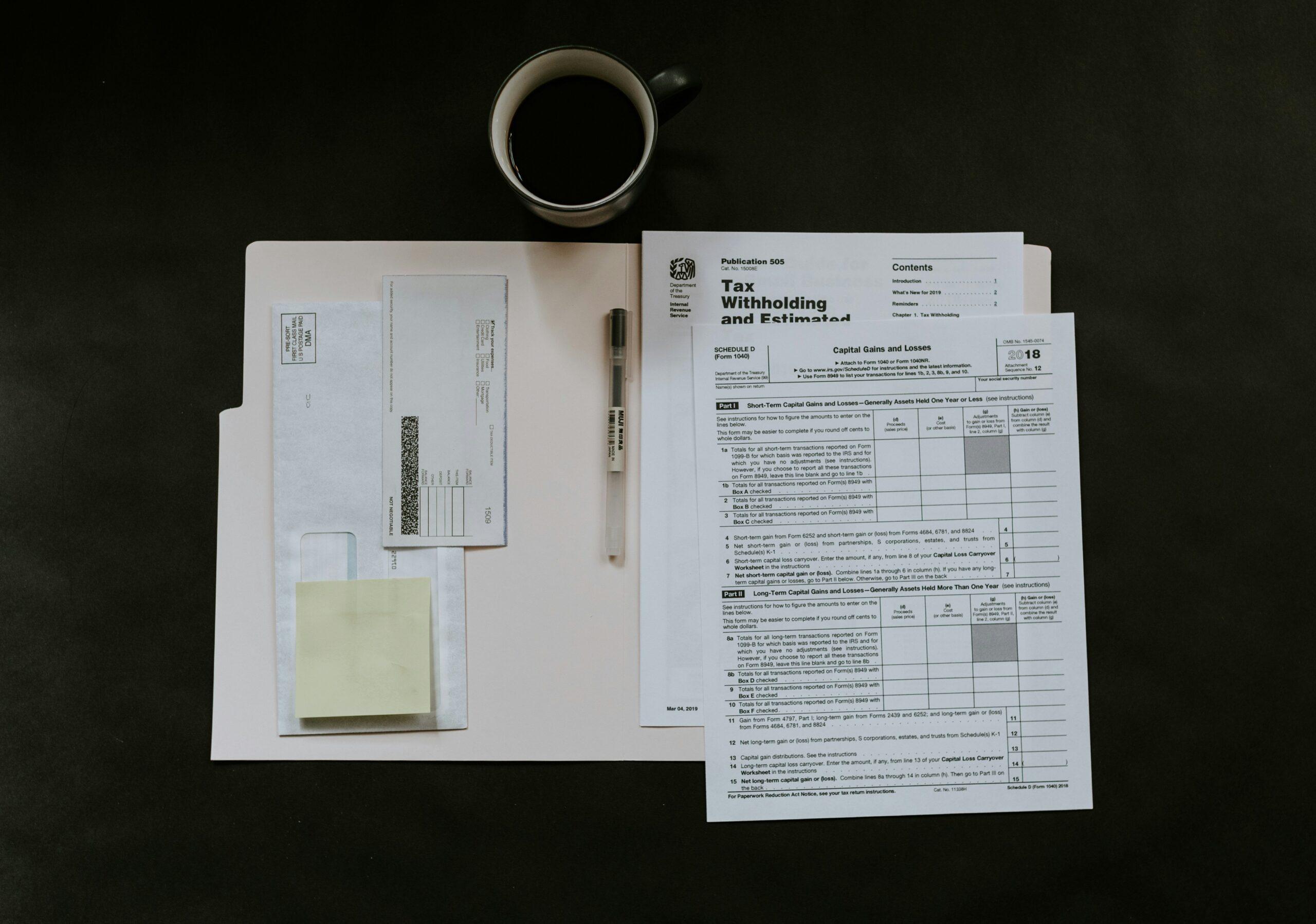 Stack of asbestos claim documents on a desk with pen and glasses