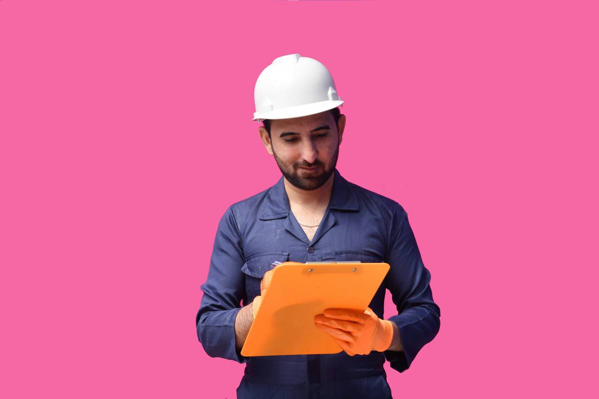 A warning sign on a wall reading 'Caution: Asbestos Hazard'